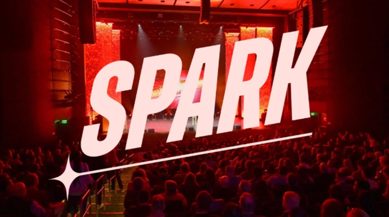 SPARK event theater crowd in red stage light